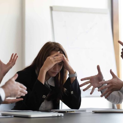 Frustrated,Millennial,Female,Worker,Sitting,At,Table,With,Colleagues,,Felling